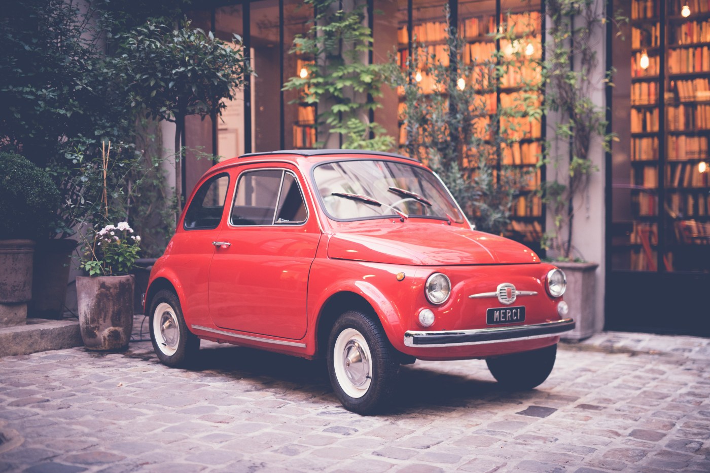 Red Fiat in courtyard in Italy